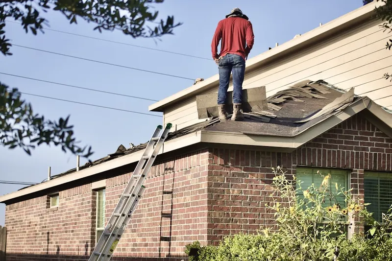 Professional roofer working on a residential roof in San Mateo
